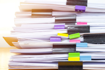 Stacks documents files with black clip. 