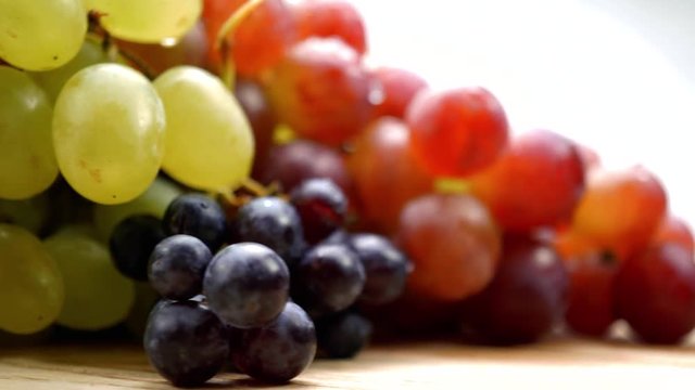 Fresh organic grapes collection with water drops rotating on a turn table. Macro. 4K