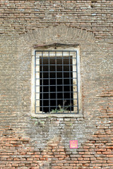 Fototapeta na wymiar Prison cell wall with a window with bars