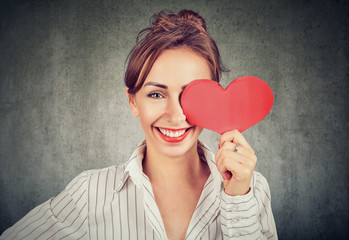 Beautiful girl holding heart shape