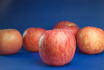 Pink apples on a blue background