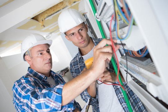 young electrician worker in fuse board