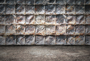 Industrial grunge background, room with walls of rusty metal plates and dirty metal floor