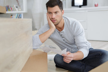 man assembling furniture at home