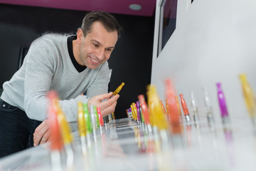 man picking a vape flavor