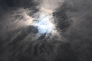 Reflection of the moon and sky in the water. Full moon in the dark sky. Thunderclouds in the sky. Reflection of the sun in the water. The sun comes out of the clouds. Dramatic background.
