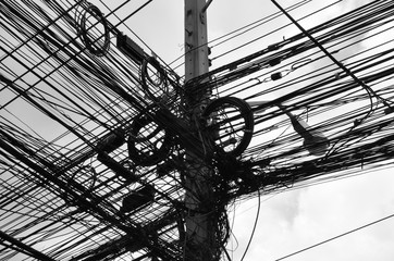 Concrete telegraph pylon with a mass of telegraph wires and coils