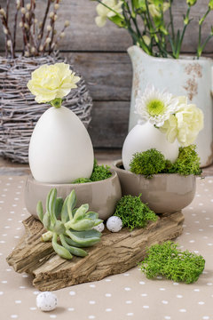 Floral arrangement with goose egg, carnations, chrysanthemum and moss.