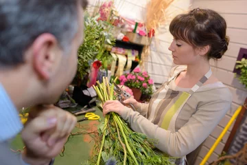 Door stickers Flower shop female florist preparing bouquet of flowers in flower shop