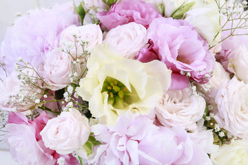 Bouquet with pink peonies, roses and yellow eustomas (lisianthus)