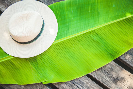 palm leaf, straw hat Summer background Top view