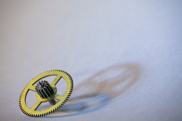 Yellow metal gear on white background