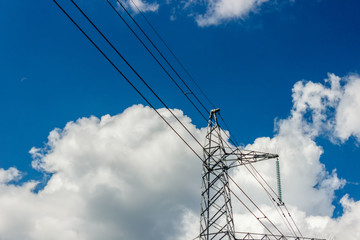 Power pylons and high-voltage lines against the background of the cloudy sky, power lines.