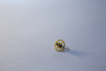 Yellow metal gear on white background