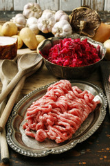 Raw pork and beef ground meat and vegetables.