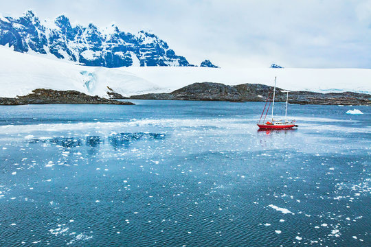 sailing boat in Antarctica, travel by yacht cruise, beautiful remote tourism destination