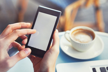 closeup of hands holding mobile phone smartphone with empty blank screen