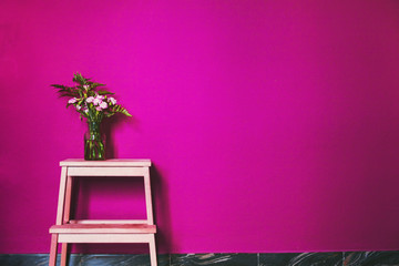 pink color in interior design decoration, painted wall and vase with flowers