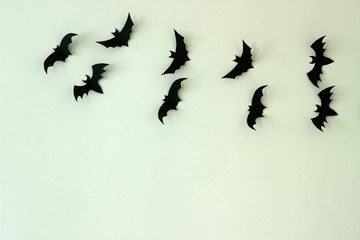 A wall decorated with bats from cardboard. Halloween concept.