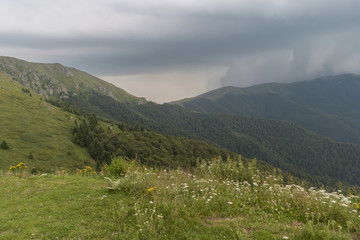 Fototapeta na wymiar Beautiful mountain view with upcoming storm from the hills on the path to the Eho hut. The Troyan Balkan is exceptionally picturesque and offers a combination of wonderful mountain scenery, fresh air.