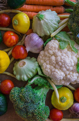 Different vegetables, small patissons, along with other vegetables, cauliflower, broccoli, garlic, cucumbers grown on an eco-farm