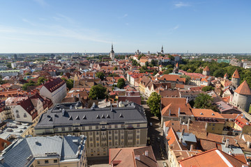 Fototapeta na wymiar Churches, city walls, towers and other old buildings at the Old Town in Tallinn, Estonia, viewed from above on a sunny day in the summer.