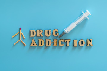 drug addiction concept. human figure, drugs, drug addiction on a blue background