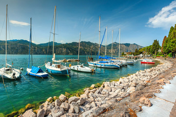 Fototapeta na wymiar Spectacular small harbor near Malcesine resort, lake Garda, Italy