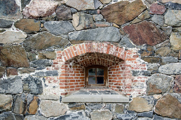 Wooden window loophole in masonry in the fortress wall