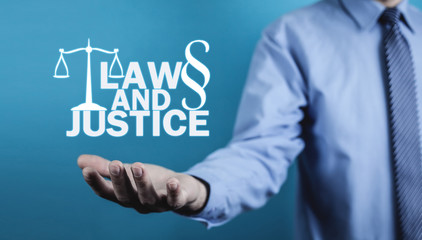 Man holding Law and Justice words with Scales and Paragraph symbol.