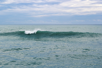Blue ocean waves breaking on a stormy day natural background