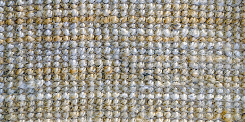A woven Mat of reeds or straw-yellow in color. The texture of dry cane. Light yellow.