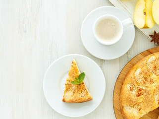 Breakfast with coffee, apple pie and apple on wooden white background, top view, empty space