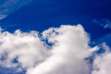 dense white clouds on a beautiful summer blue sky