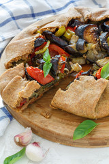 Cut free-form pie with vegetables.