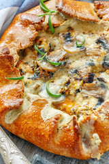 Homemade pie(galette) with mushrooms and rosemary.