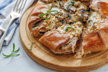 Galette with mushroom and cheese cut into pieces.