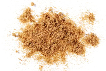 Unrefined brown cane sugar pile isolated on white background, top view