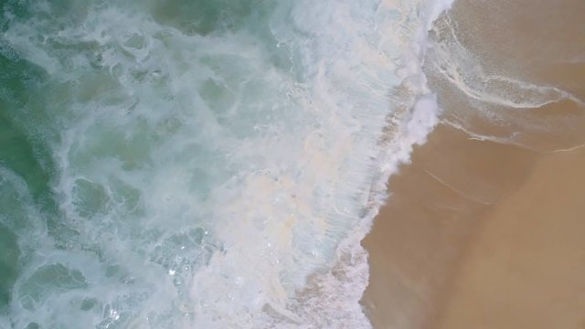 Aerial footage of Nazare beach waves on Atlantic ocean coast in Portugal