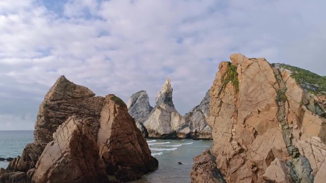 Aerial reveal of Ursa Beach on Atlantic ocean coast in Sintra, Portugal