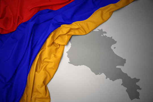 waving colorful national flag and map of armenia.