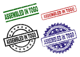 ASSEMBLED IN TOGO seal stamps with distress style. Black, green,red,blue vector rubber prints of ASSEMBLED IN TOGO text with unclean style. Rubber seals with circle, rectangle, medallion shapes.