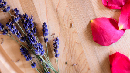 Edible Flowers fresh lavender and red rose petals on wood background flat lay