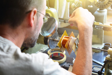 A man producing an electrical copper coil for high-voltage transformer - obrazy, fototapety, plakaty