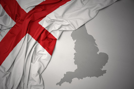 waving colorful national flag and map of england.