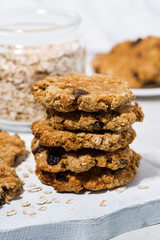 homemade oatmeal cookies with raisins on wooden board, vertical