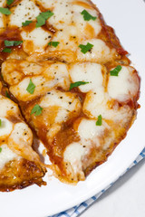 pizza with mozzarella on a white plate, vertical closeup