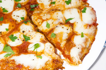 pizza with mozzarella on a white plate, closeup