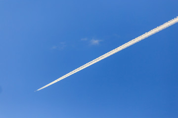 Trail from an airplane in a blue sky