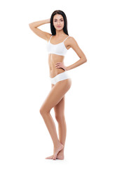 Fototapeta premium Fit and sporty girl in white swimsuit. Sport, fitness, diet, weight loss and healthcare concept.